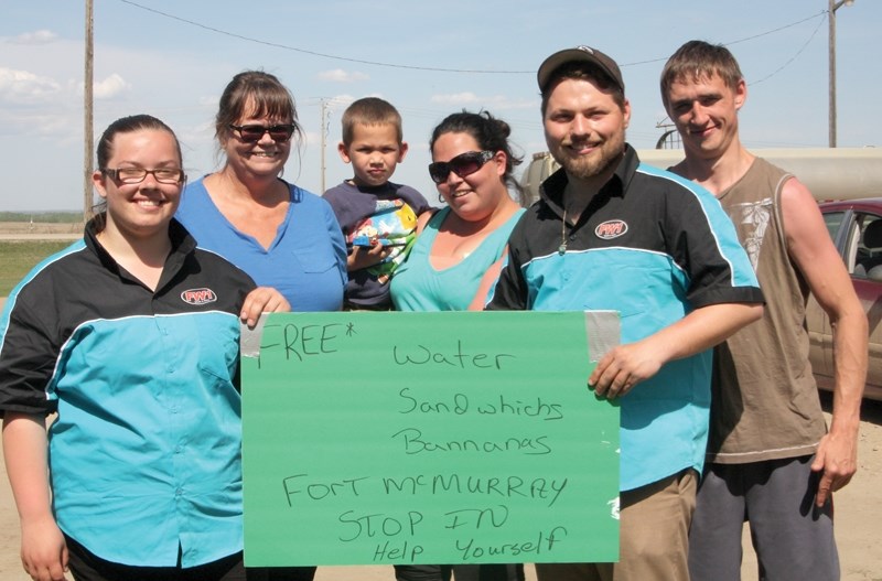A group of good Samaritans collected and distributed supplies to Fort McMurray evacuees at the Clyde Petro Canada on Wednesday. Pictured (L-R) Alex Judson, Teresa Sheflin,