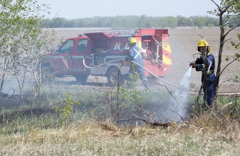 Westlock Rural firefighters battle a small brush fire at Range Road 21 and Township Road 612 May 6. It took firefighters several hours to ensure the flames were quenched. The 