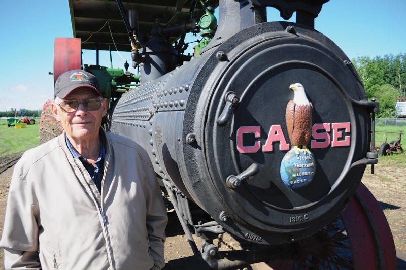 Bernard Wiese stands next to a 1919 Case steam tractor that he and fellow Canadian Tractor Museum club members spent four years restoring. The engine was a major attraction