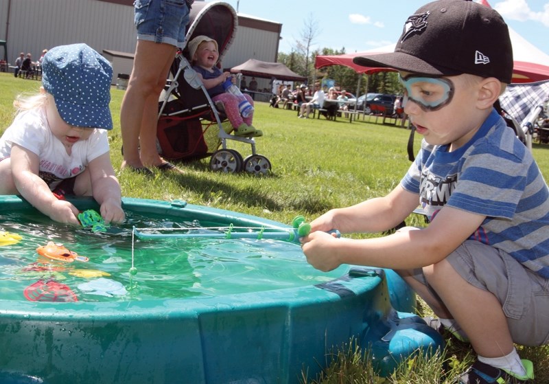 The Clyde and District Agricultural Society hosted its fifth annual Summer Solstice Festival June 18, drawing large crowds due to the sunny weather. Kash Neumiller, 3, hopes