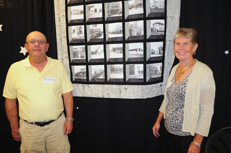 Lorne Westgate and Penny Holmes, descendents of Westlock’s founder William Westgate, pose with a centennial quilt commemorating the town’s 100-year history.