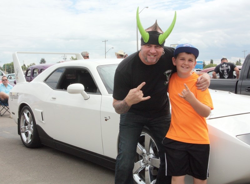 &#8220;Horny Mike &#8221; from reality TV series Counting Cars poses with youngster Kaine MacKinnon at Precision Collision Repair and Restoration’s second annual show N’