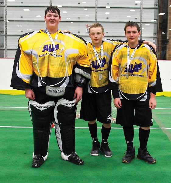 Westlock’s Trace Stewart, Zach Basisty and Cole Perkins (L-R) celebrate their silver medal performance as part of the Zone 5 lacrosse team at the Alberta Summer Games in