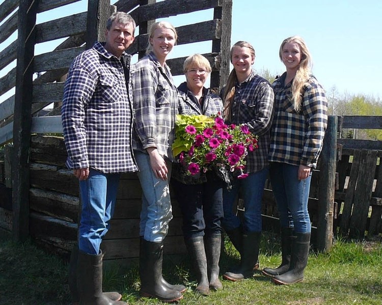Rod, Andria, Janet, Jessica and Briana Carlyon pose near a cattle ramp on their family farm. The Carlyons will open their farm to the public for tours as part of Alberta Open 