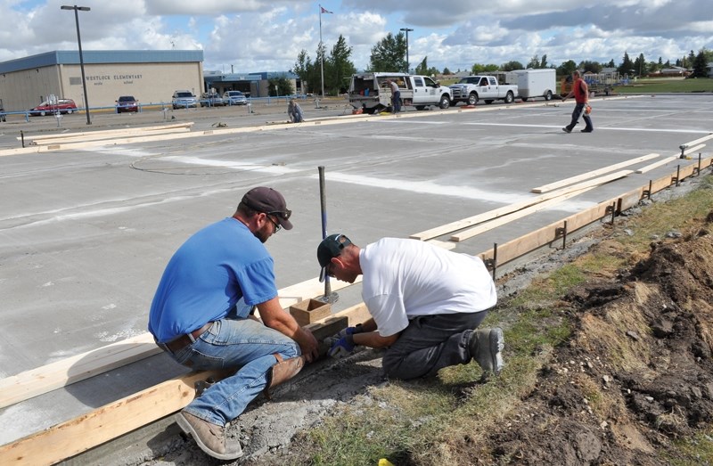 Construction crews begin work Aug. 18 on the curb joints at Westlock Elementary School’s new parking lot.