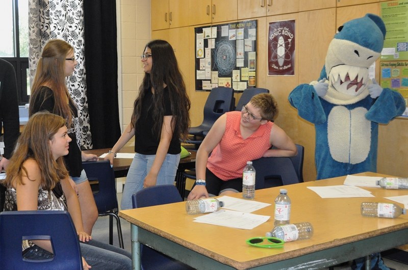 L-R: St. Mary School’s Lenaya Wade, Chandra Croteau, Chelsey Ammar, Sawyer Dutka and Quinn McLaren (shark costume) get ready for the school year with the first student