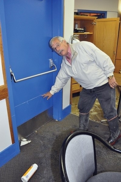 Paul Taverner marks the high water line in the basement of the Westlock Legion. This is the third in the last few years that the Legion&#8217;s basement has flooded.