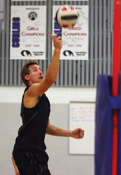 Jacob Williston tips the ball during the R.F. Staples senior boys volleyball team’s first practice of the season Aug. 31 in the school’s gymnasium.