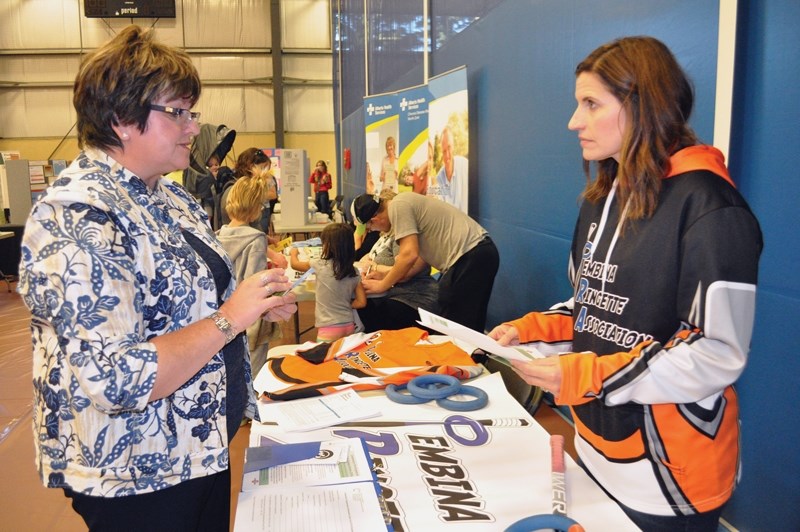 FCSS program coordinator Carol Kassian talks with Pembina Ringette Association team manager Lori Borduzak during the annual Community Showcase Night hosted Sept. 7 at the
