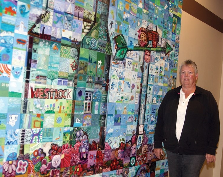 Westlock Community Art Club secretary Peggy Nadeau poses with a piece of art at the club’s Rotary Spirit Centre gallery. The club will host a art show and sale Sept. 30 and