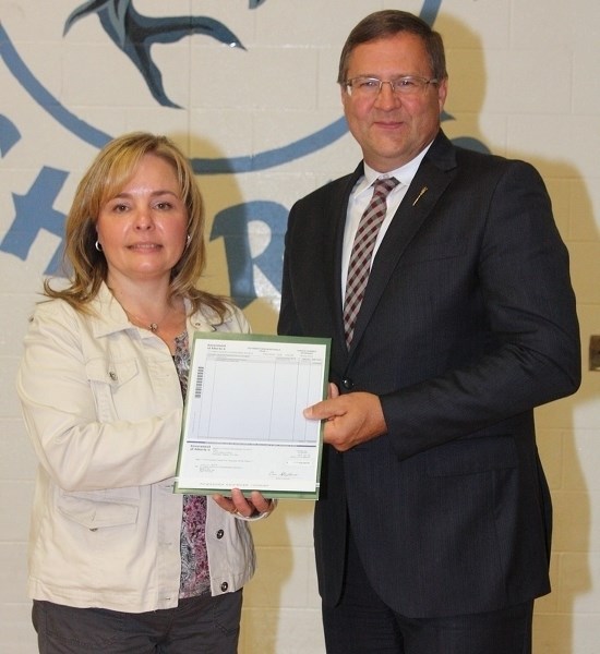 St. Mary School Fundraising Society chair Wendy Batog accepts a $125,000 grant from Barrhead-Morinville-Westlock MLA Glenn van Dijken on Monday, Sept. 26. The funding was