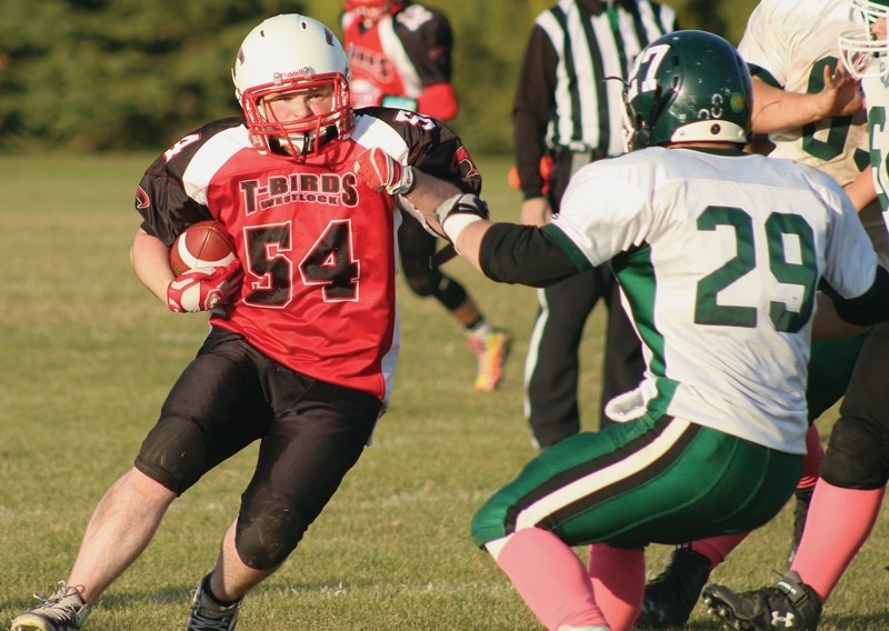 Thunderbird Aiden Marshall prepares to bowl over Pacer Adam Koons during the club’s 40-0 Oct. 6 home win. The victory was their first of the season and means they’ll face the 