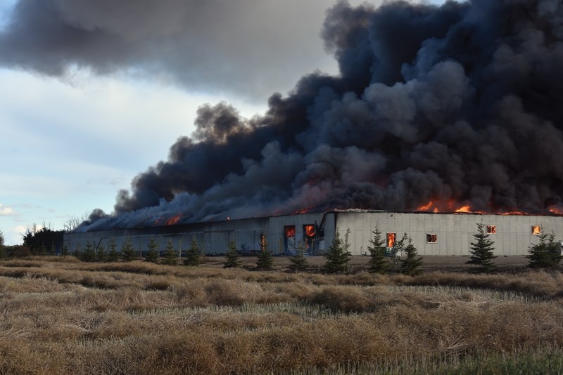 The scene Sept. 19 near Busby as the multi-million dollar Severson Free Run Barn burns. The facility’s owner says they plan to rebuild.