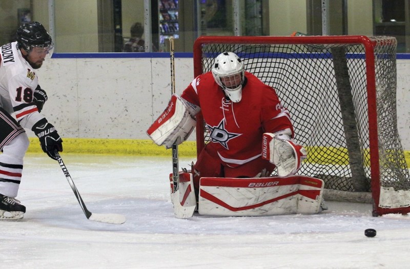 Warriors’ forward Mike Podruzny fires a shot just past Daysland Northstars’ goaltender Andy Sinclair during the team’s 7-0 home opening loss on Oct. 21.