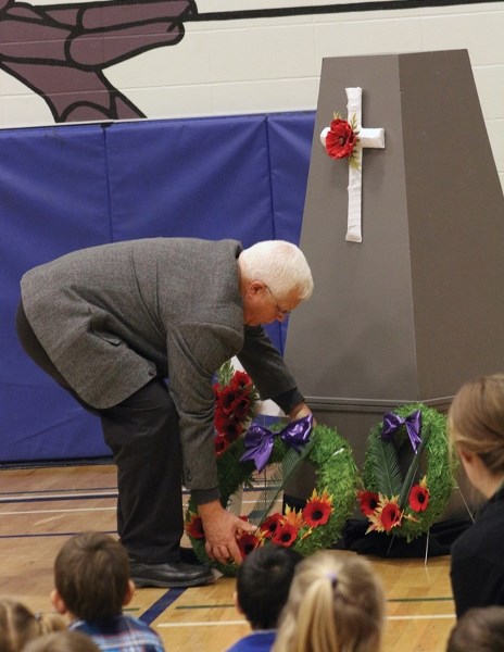 Village of Clyde mayor Doug Nyal lays a wreath at Eleanor Hall School’s Nov. 4 pre-Remembrance Day ceremony.