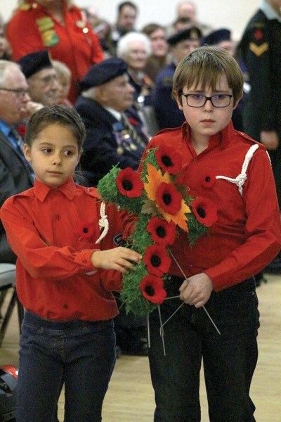 Area residents paid their respects at Remembrance Day services Nov. 11. Junior Forest Wardens AnaClare Pollard and Kailan Smith-Kwasney present a wreath at the Westlock and