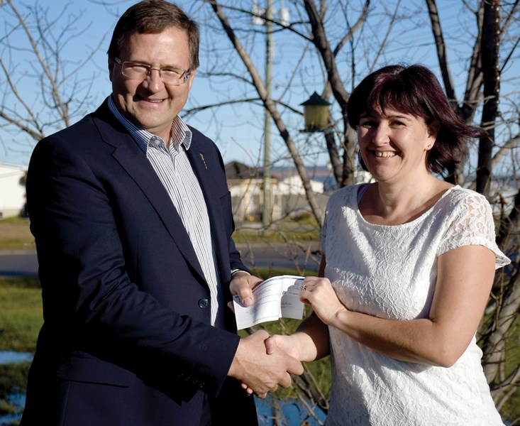 Clyde &#038; District Ag Society secretery-treasurer Shonda Sawchyn accepts a $48,000 cheque from Barrhead-Morinville-Westlock MLA Glenn van Dijken Nov. 14 to repair the