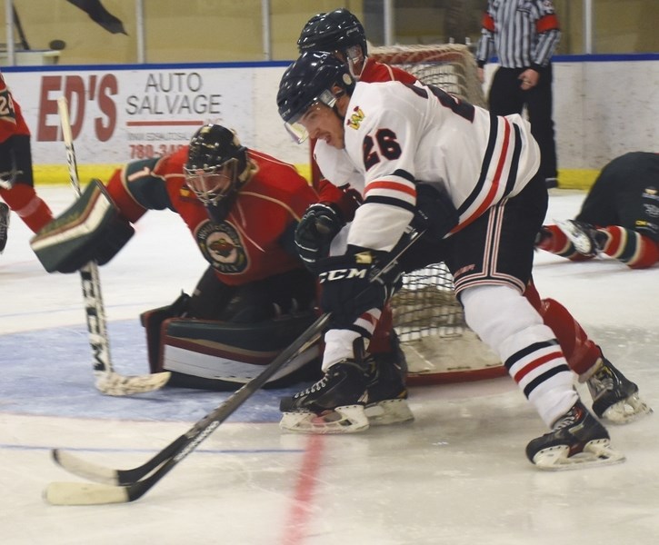 Warrior Philip Ferenac fights to the net during a clash with the Whitecourt Wild at the Rotary Spirit Centre Nov. 25. The Warriors netted a 5-3 con-tinuation win against the