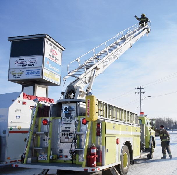 Town of Westlock firefighter Brian Hegedus braced -30 degree weather atop the ladder truck Dec. 10. Hegedus made it down safely, while the event brought in $2,028 in cash