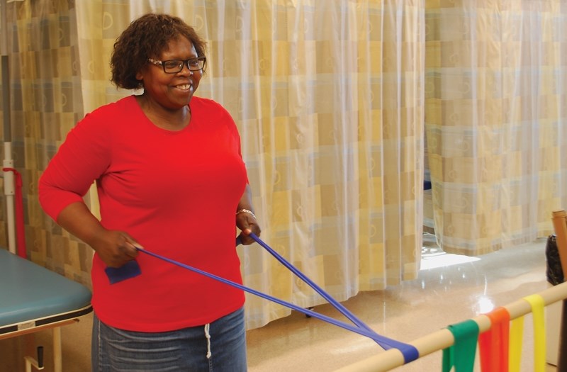 Community support worker Janet Neil pulls a resistance band at the Rotary Spirit Centre during her time in the Alberta Healthy Living Program, which helps people with chronic 