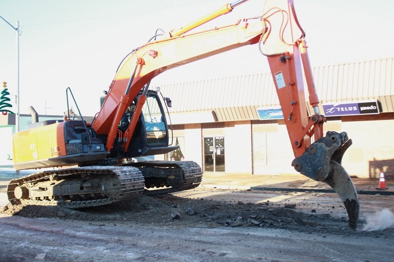 Cory Dering breaks the surface of the pavement on 106 St. between 99 and 100 Ave. Dec. 19 after a water main break flooded five businesses along the block.