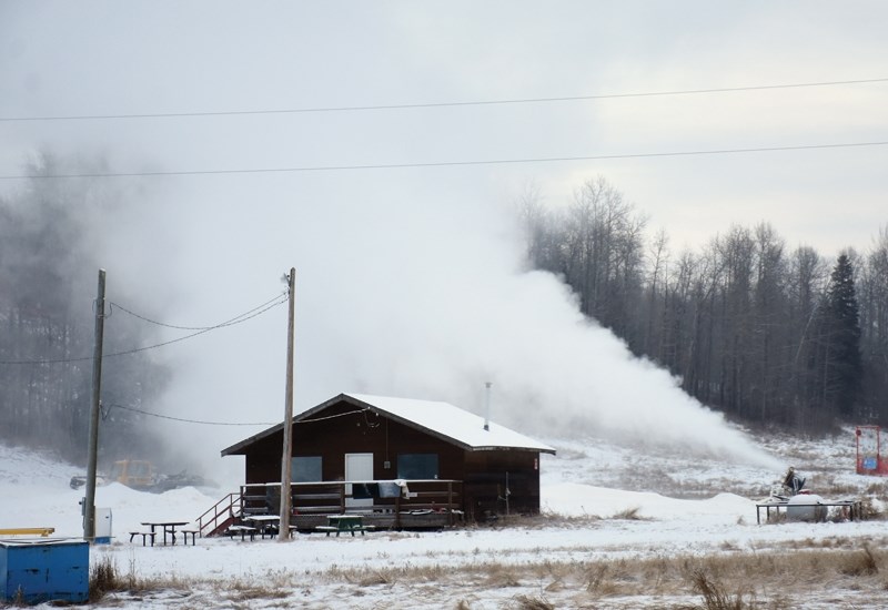 Snow blowers and graters at the Pine Valley Resort in Tawatinaw make snow earlier this month. The hill was closed Dec. 23 after being open the previous day.