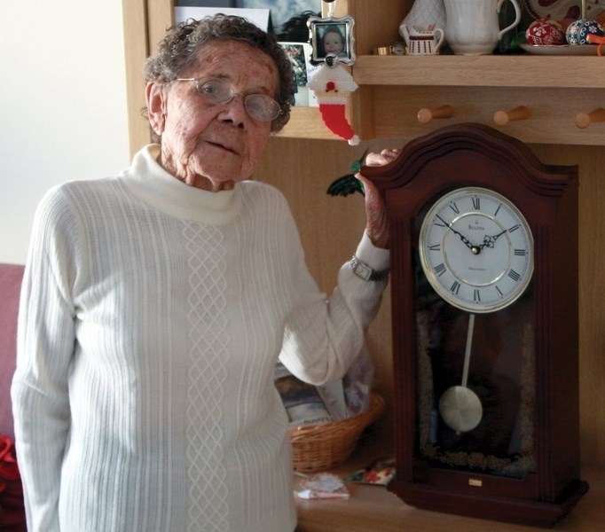Kay Nestorovich, 95, displays a clock she received unexpectedly from the Alberta government after volunteering with Alberta Health Services for 65 years.