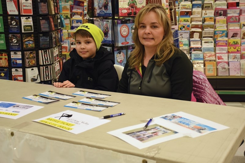 Tawatinaw Valley Freerider Brett, 11, Batog and mom Wendy man the raffle booth at Sobeys Jan. 19. The ski club is selling $10 raffle tickets in con-junction with three other