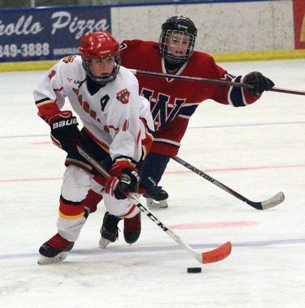 Pee wee Warrior Kale Meinczinger lugs the puck over the blue line during a 3-3 tie versus the Wetaskiwin Lions at the Rotary Spirit Centre Jan. 29.