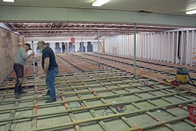 Gary Lazowski (l) and Nelson Joseph measure the level of new flooring being installed at the Westlock Bowl.
