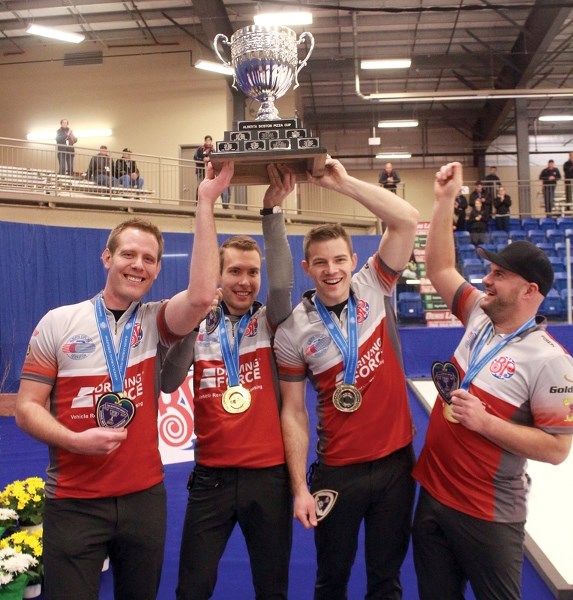 Karrick Martin, Brendan Bottcher, Brad Thiessen and Darren Moulding of Team Bottcher hoist the BP Cup after defeating Team Appelman 6-5 in Sunday night’s final at the Rotary