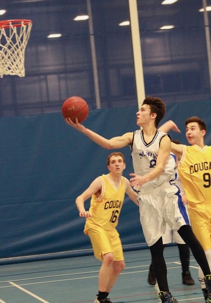 St. Mary Shark Dominic Terrault breaches a sea of Breton Cougars during their opening game at the W. J. Kallal Memorial Tournament Feb. 10. The young Sharks matched their