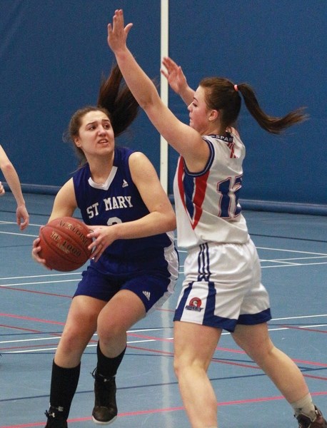 Shark Mackenzie Lunger swims around a Rimbey defender during the club&#8217;s opening game loss at the Cathy Mitchell Memorial Tournament at the Rotary Spirit Centre Feb. 24.