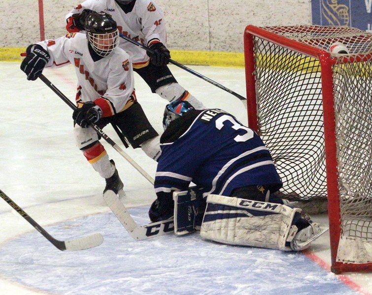 Warriors forward Jonah Bennett tries to sneak the puck past the Slave Lake Thunder goaltender during the March 13 1-0 Game 1 loss in the best-of-three gold medal final series 