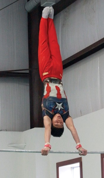 Jile Mu of the Chinese National Gymnastics Team practices on the high bar at the Pine Valley Gym Centre March 24. The team was in Tawatinaw to practice as part of an