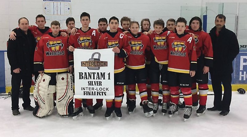 The Westlock Bantam Warriors poses with their Tier 1 1660 Hockey League silver banner. L-R: assistant manager Paul Gerig, Jordan Garbiar, Jona-than Zeise, Cole Beaver,