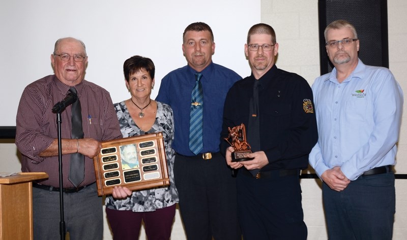 Presenting the Glenn Latimer Memorial Community Service Award for 2017 to Trevor Pollard (second from right) are Westlock County reeve Don Savage, county director of planning 