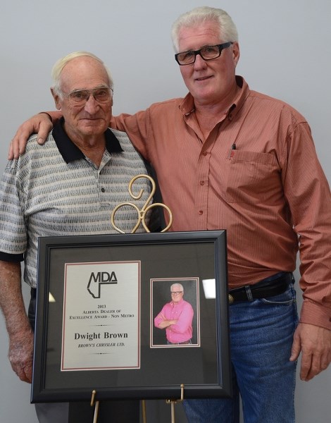 Dwight Brown, right, is presented the Motor Dealers’ Association (MDA) Dealer of Excellence award in the fall of 2013. To his left is Albert Miller, the only person Dwight