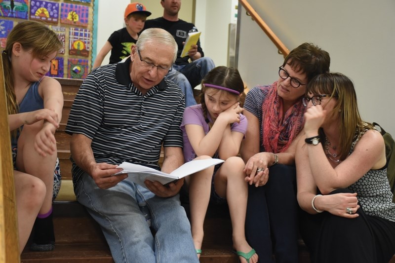 Grandpa Matt Meinczinger (second from left) narrates his granddaughter’s story to family (L-R) Jenna Strydhorst, Jaylene Strydhorst, Doris Meinczinger and Carmen Meinczinger.