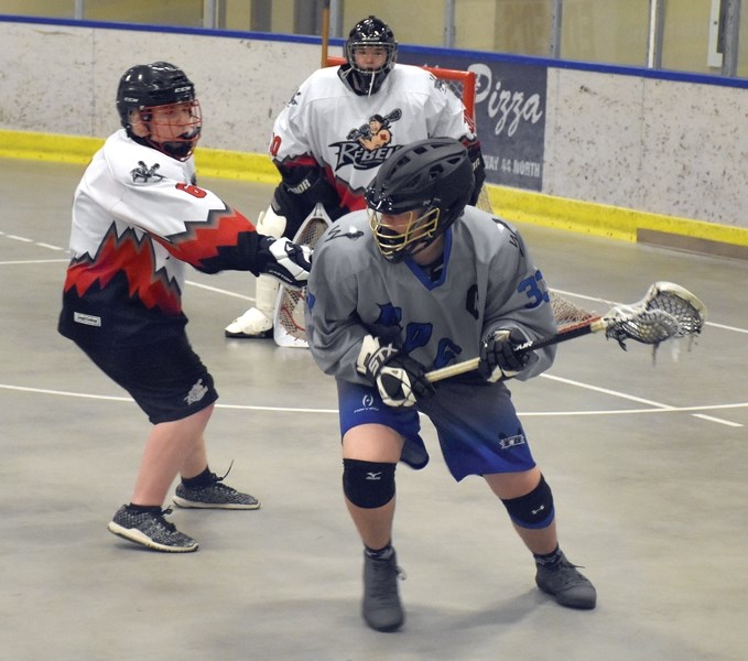 Midget Rock Blair Lobsinger looks for a pass under the watchful eye of a Fort Saskatchewan Rebel defender during the club’s 14-4 win over the Rebels at the Rotary Spirit