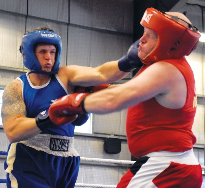 Westlock RCMP Const. Craig Armstrong (l) lands a punch on Scotty Cartwright at the Fight For Hope boxing fundraiser in support of Kids With Cancer Society and Ronald McDonald 