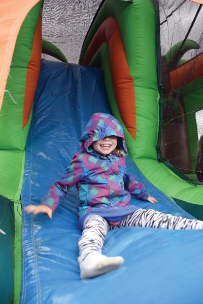 Alana Larocque blasts down the slide at an inflatable bouncy castle during Busby Farmers Day June 10.