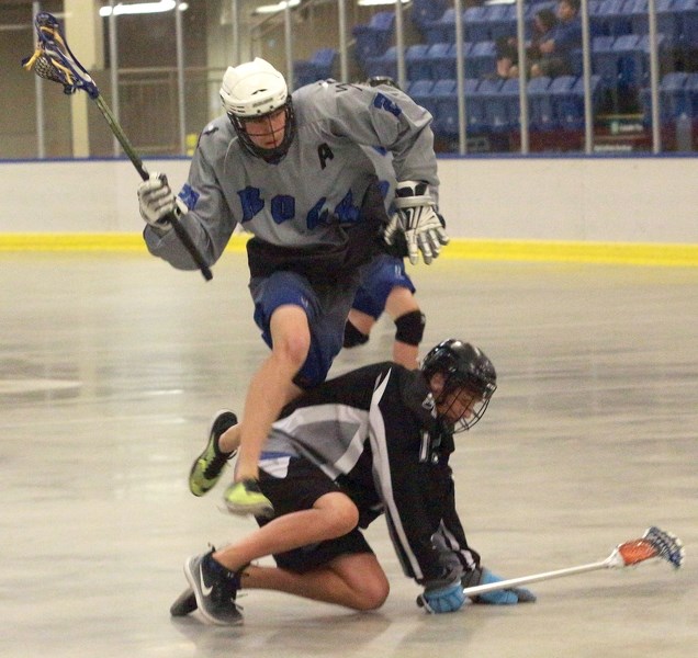 Midget Rock Trenten Durell bounds over a Beaumont Raider during the club’s 13-2 June 18 home win. The victory capped a perfect season for the Rock who went 13-0 in the GELC.