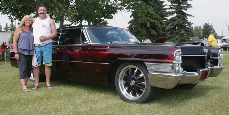 Corey and Kelly Newman pose next to their 1968 Cadillac Coupe de Ville at the 30th annual Wheels of Class Show &#8216;N Shine July 9. This was the final show the club will