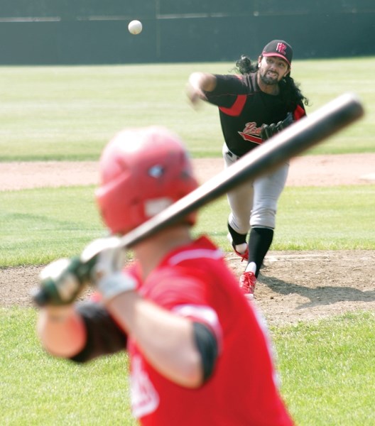 Red Lion Pat Rains deals to a Cold Lake Cardinal batter during the club’s 15-4 loss in the first game of the John Golonowski Invitation tournament at Keller Field July 8. The 