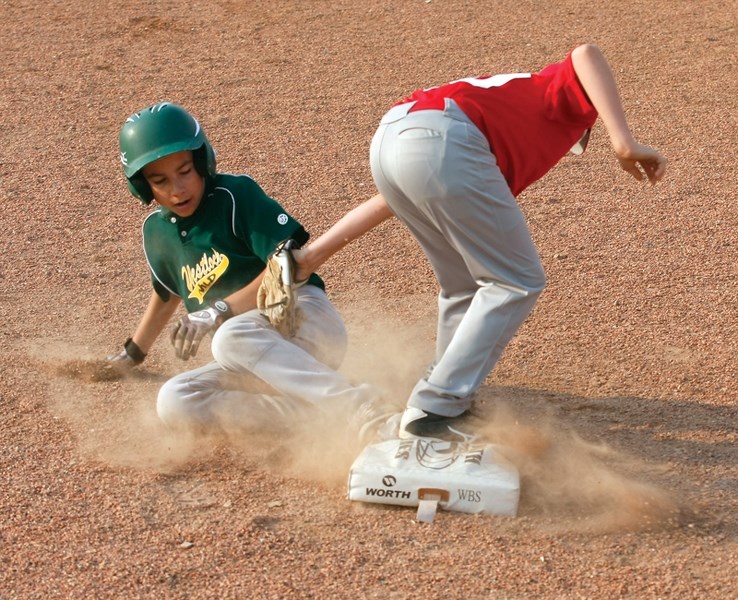 Westlock Wild&#8217;s Kasyn Pipke slides into third during the club’s 17-16 July 12 win over the Athabasca Trappers in Westlock.