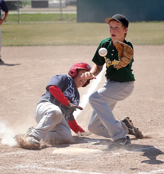 Westlock Wild Thomas Oloske prepares to tag out a St. Paul Storm runner during July 22 action at the Pee Wee