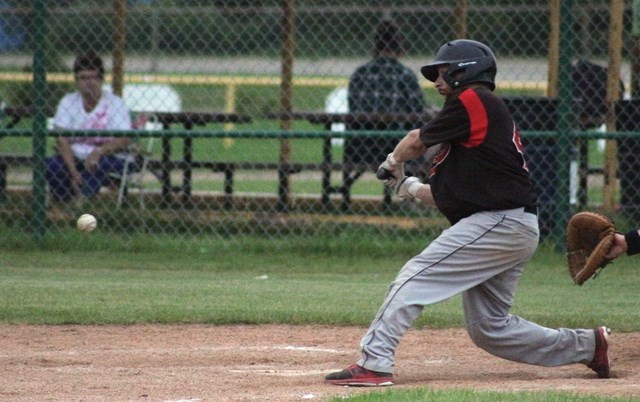 Jordan Brand takes a swing at the ball during the Red Lions’ last regular season game Aug. 3 in Westlock. The Red Lions are now awaiting the re-sults of the Aug. 8 match