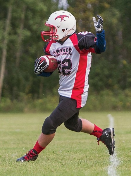 Thunderbird Deano Allcock goes for a run during a 48-22 victory against the Athabasca Pacers Sept. 8. Allcock was lost for the season after break-ing his ankle.