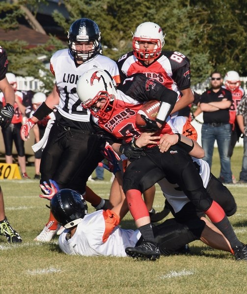The St. Paul Lions surround Thunderbird Aidan Walker during the club’s 48-8 Sept. 15 home loss. The Thunderbirds are back in action Sept. 22 for Friday Night Lights.